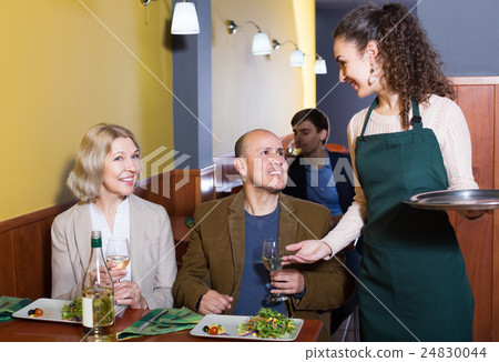 Young waitress taking order at table 24830044