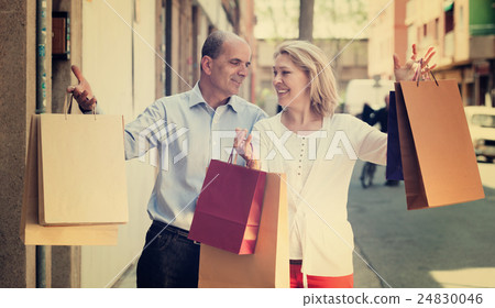 Lovers couple having shopping tour in city and smiling 24830046