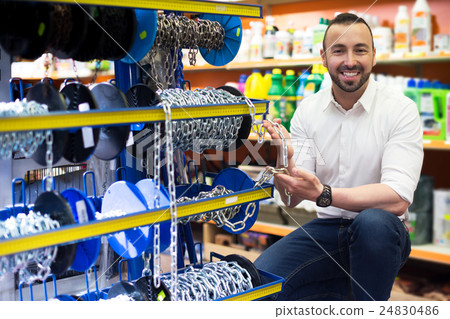 Man picking metallic chain 24830486