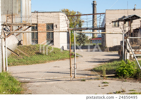 Abandoned factory gate Abandoned factory gate 24850495
