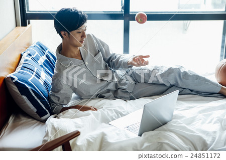Male relaxing in bed 24851172
