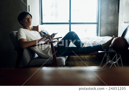 A man relaxing in the room 24851205