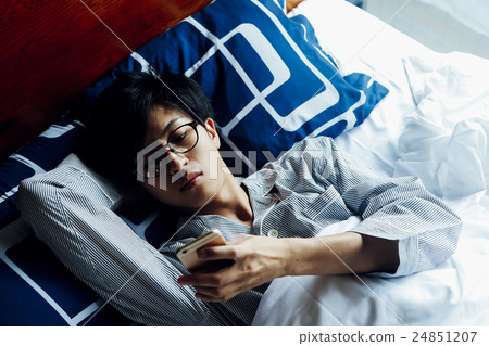 Male relaxing in bed 24851207