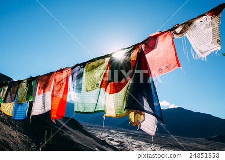 Colorful prayer flags with sun shining through 24851858