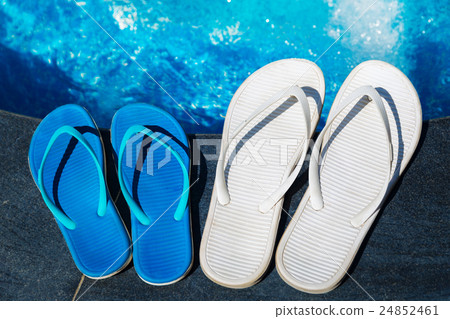 Beach slippers on border of swimming pool 24852461