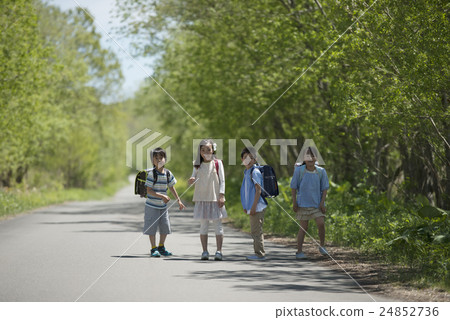 Elementary school student smiling at a single road Elementary school student smiling at a single road 24852736