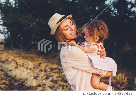 mother and daughter together outdoors 24853452