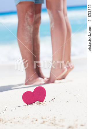 Couple of male and female legs on beach 24853863