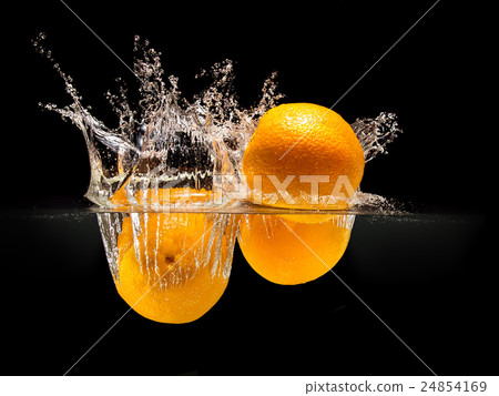 Group of fresh fruits falling in water on black 24854169