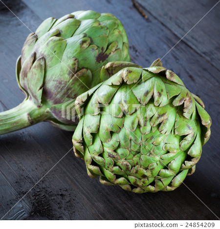 Fresh green artichokes on wooden table 24854209