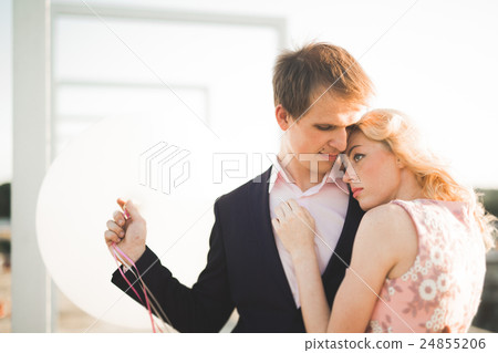 Young couple in love posing on roof with perfect Young couple in love posing on roof with perfect 24855206