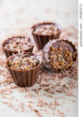 Four sweet cupcakes made from nuts and chocolate Four sweet cupcakes made from nuts and chocolate 24860372