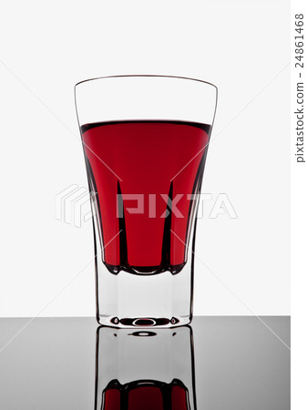 Glass with red drink on white background Glass with red drink on white background 24861468