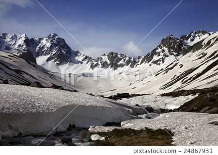 River with snow bridges in spring mountains  24867931