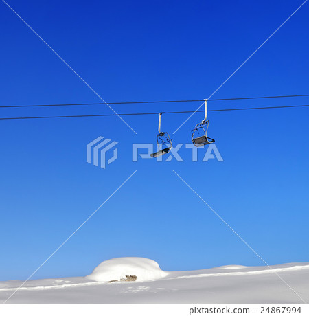 Chair-lift and blue clear sky at sunny day 24867994