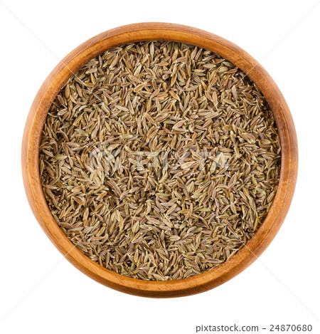 Cumin seeds in a wooden bowl over white Cumin seeds in a wooden bowl over white 24870680