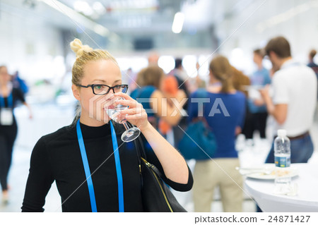 Business woman drinking glass of water during Business woman drinking glass of water during 24871427
