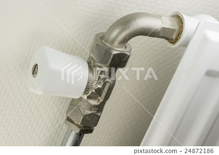 White radiator button on a heating element. 24872186