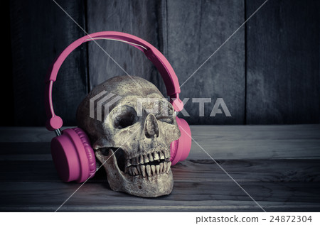 Still life  skull  with  headphones on wooden 24872304