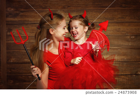 Family mother and child daughter celebrate Halloween in devil co 24873908