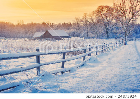 Rural house with a fence in winter Rural house with a fence in winter 24873924