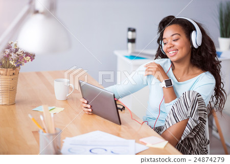 Joyful smiling woman listening to music Joyful smiling woman listening to music 24874279