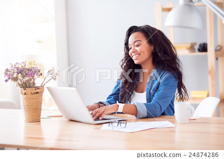 Positive woman sitting at the table Positive woman sitting at the table 24874286