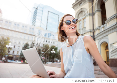 Beautiful young woman holding a laptop Beautiful young woman holding a laptop 24874591