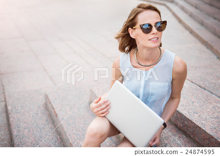 Cute young woman holding a laptop 24874595