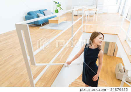 A woman ascending a staircase 24879855