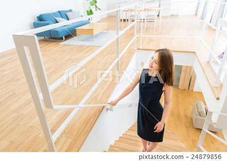 A woman ascending a staircase 24879856
