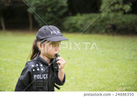 A girl in a police costume blowing a whistle 24886350