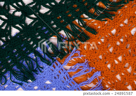 Knitted woolen female shawls on wooden background Knitted woolen female shawls on wooden background 24891587