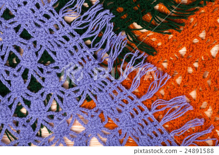 Knitted woolen female shawls on wooden background 24891588