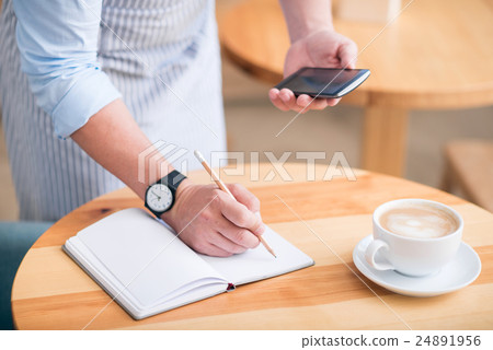 One man making some notes 24891956