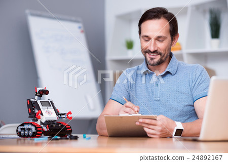 Positive man sitting at the table 24892167
