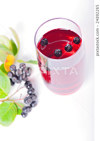 Glass of aronia juice with berries, overhead view Glass of aronia juice with berries, overhead view 24892265