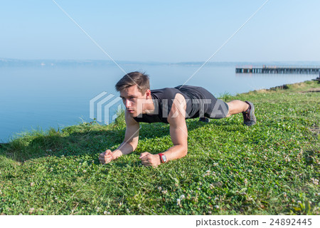 Fitness man working out his midsection core Fitness man working out his midsection core 24892445