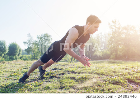 Fitness man doing clapping push-ups exercise Fitness man doing clapping push-ups exercise 24892446