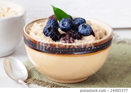 Oatmeal porridge with berries still life 24905377