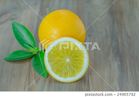 ripe orange with leaves on wooden background ripe orange with leaves on wooden background 24905782