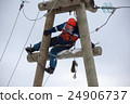 electrician working on top of an electricity pylon 24906737