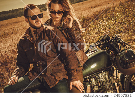 Stylish cafe racer couple on the vintage custom 24907821