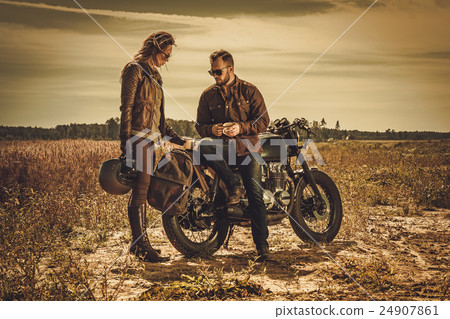 Stylish cafe racer couple on the vintage custom 24907861