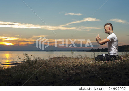 Tattoo man sitting in yoga meditation pose 24909032