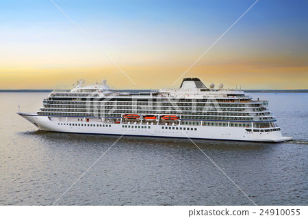 Luxury cruise ship sailing from port on sunset  24910055
