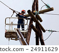 Electrician connects wires on the power line 24911629