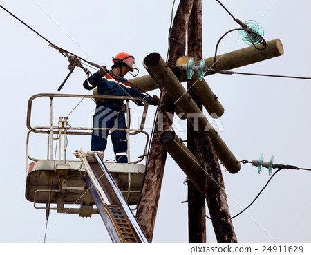 Electrician connects wires on the power line Electrician connects wires on the power line 24911629