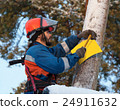 Electrician attaches to an electricity pylon yellow sign 24911632