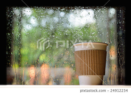 Paper cup of coffee on a rainy day  24912234